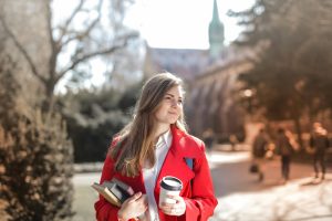 Woman in red jacket on campus