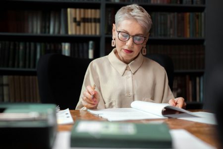woman reviewing books, representing history